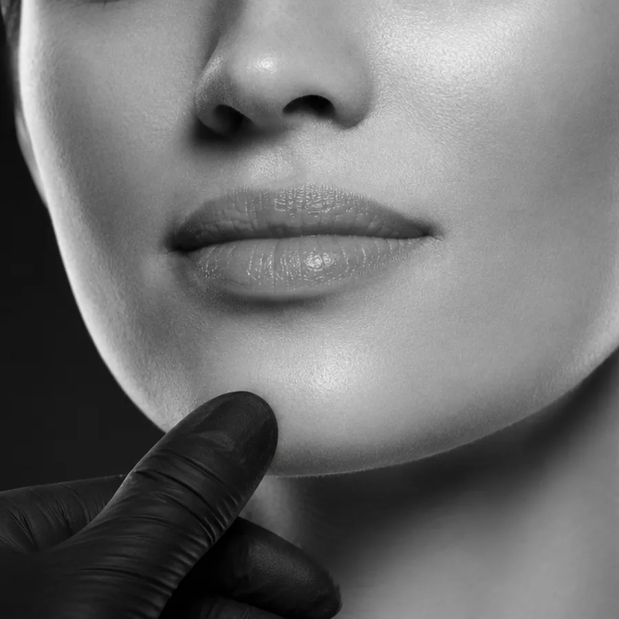 A gloved hand framing the chin, reading facial proportions